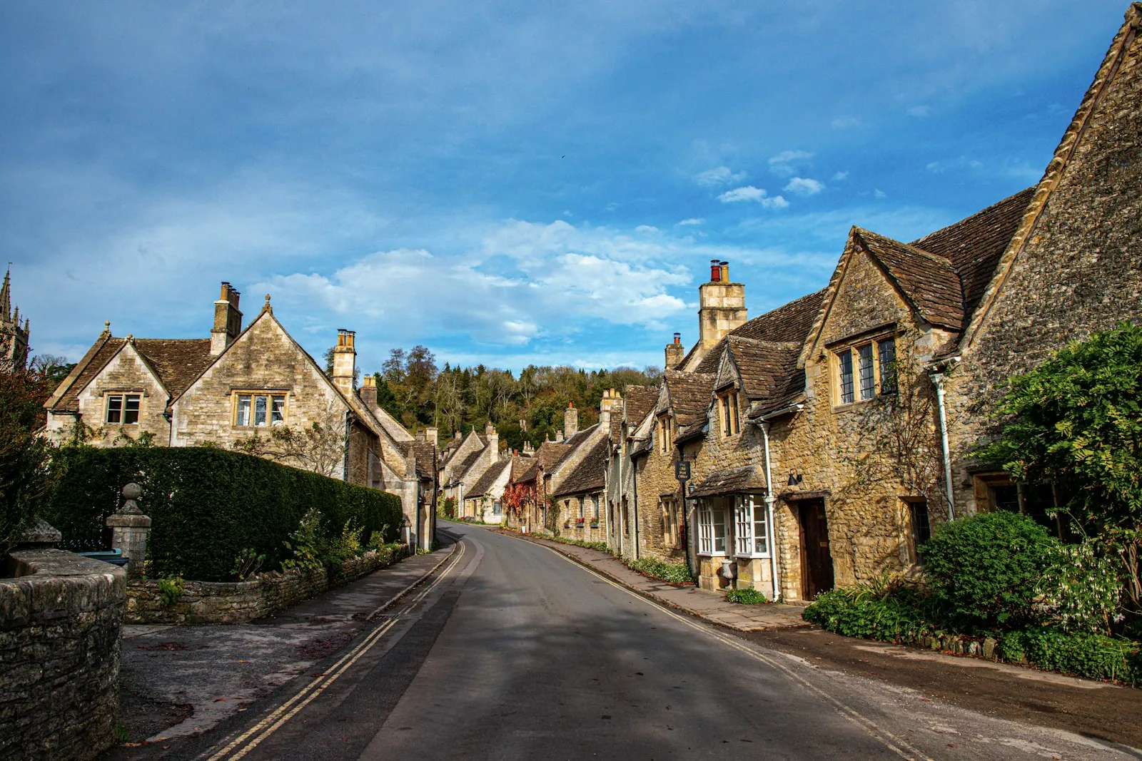A row of Cotswold-stone cottages on a village street