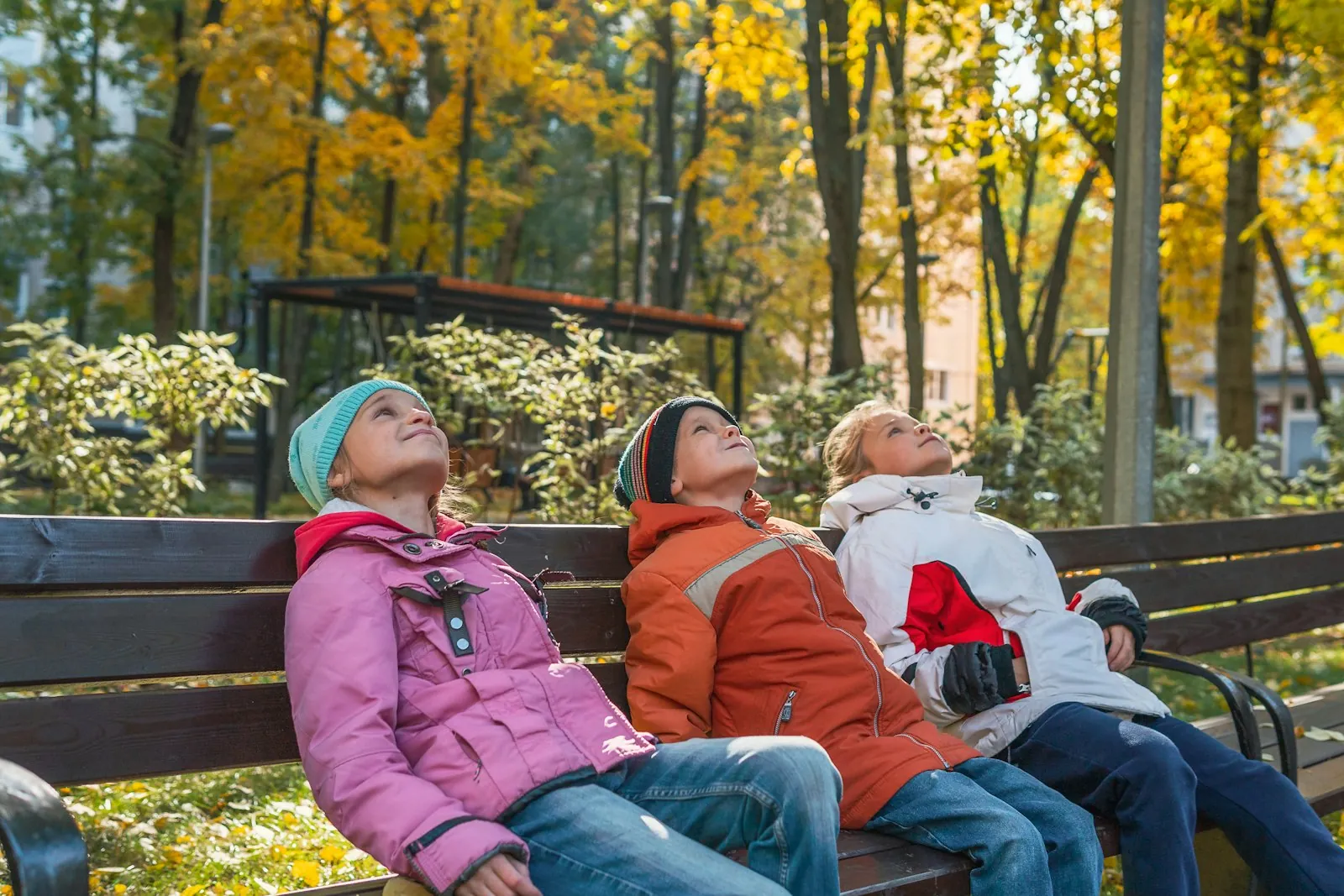 Three generations of a family sitting together outdoors